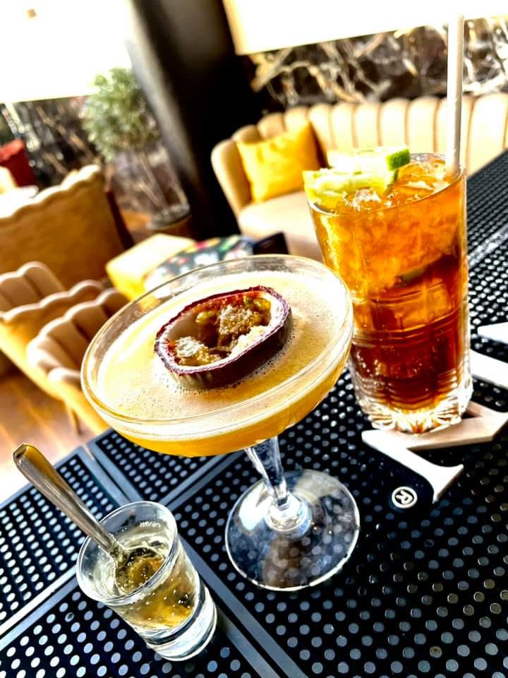 Cocktails passion et long drink sur table basse